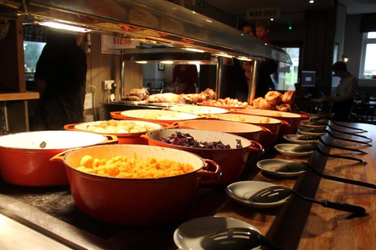 Pictures of pots on a carvery full of vegetables and potatoes