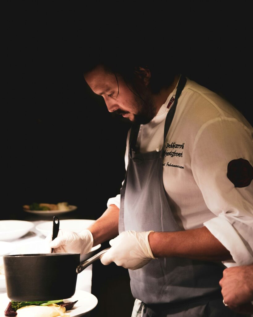 A chef concentrating on plating food