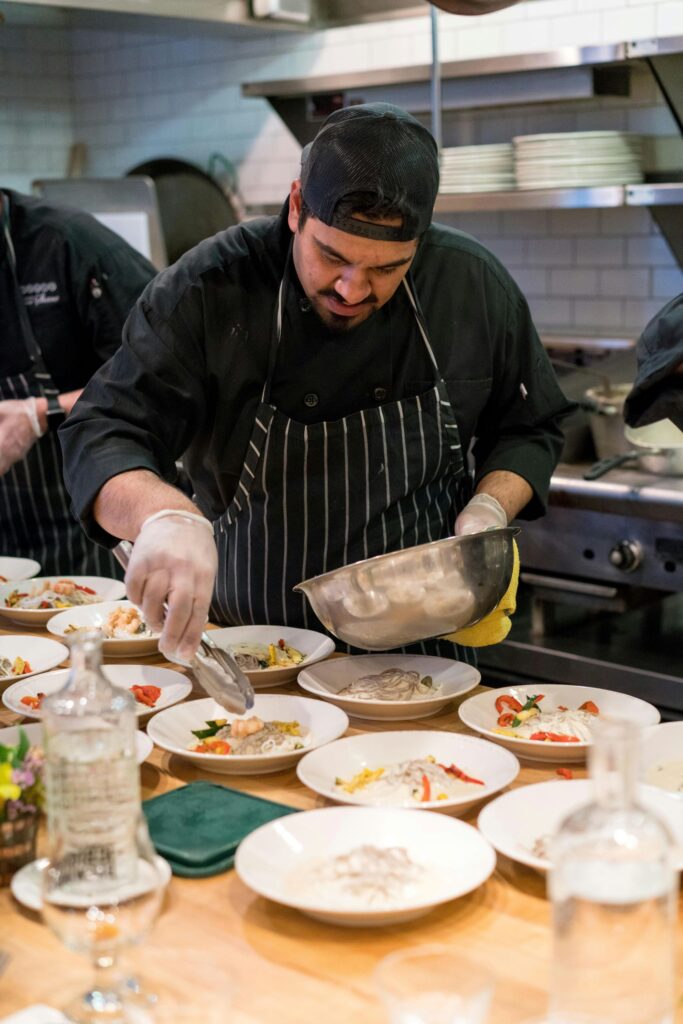 A chef plating food in the kitchen