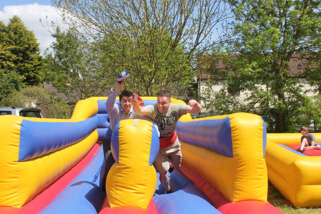 Two men having a race on an inflatable bungee run.