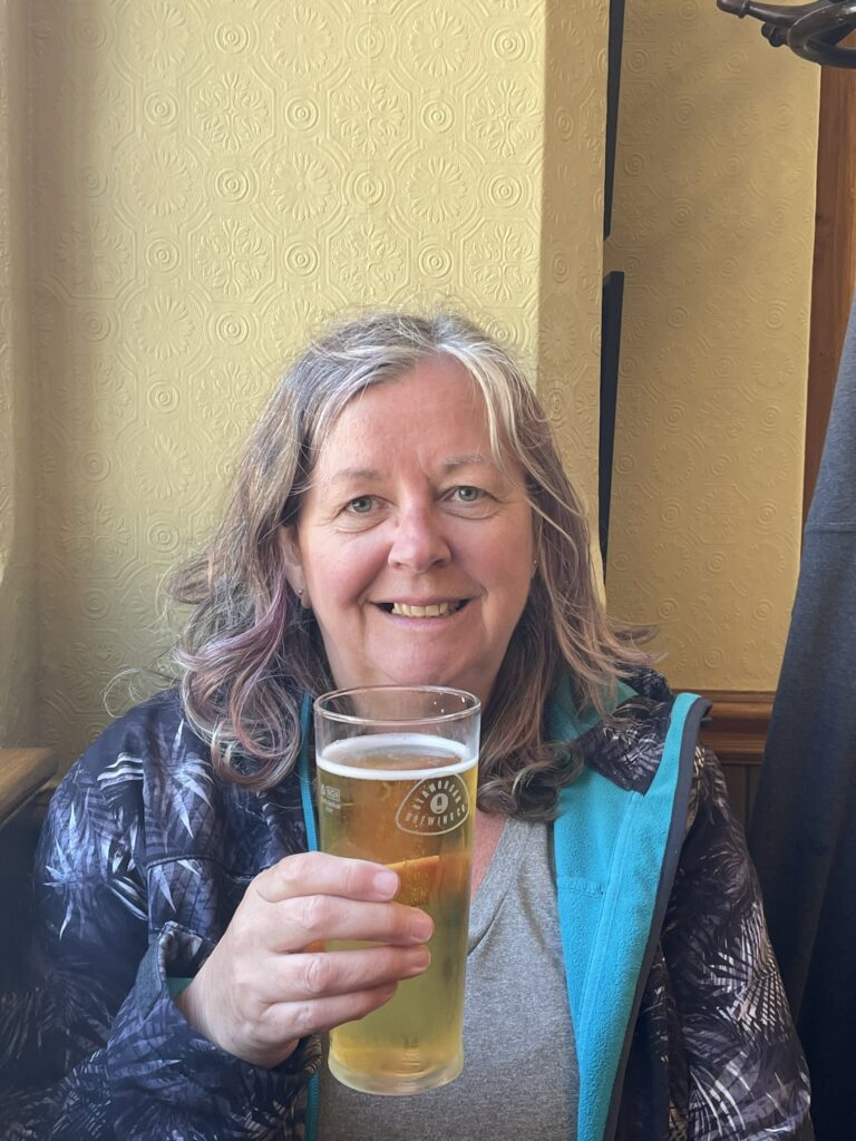 Liz enjoying a celebratory pint in the saved pub