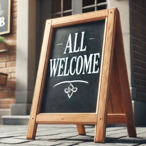 An a-frame outside a pub saying all welcome to show that transgender individuals should be welcome too.