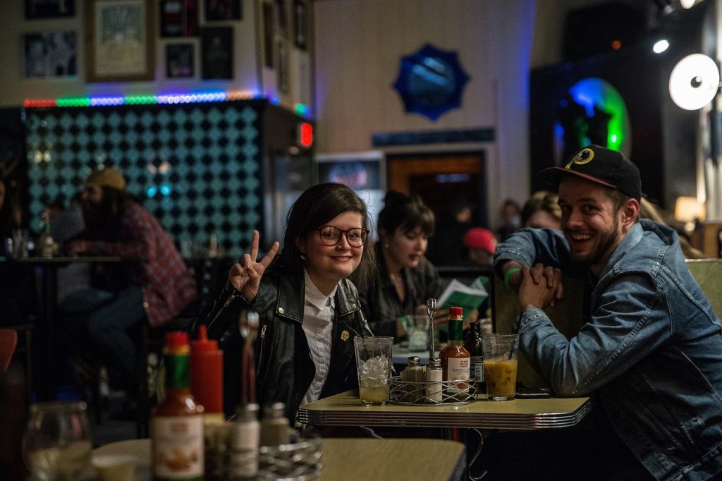 A busy pub of customers enjoying themselves.