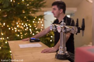 A bar tender behind a mobile bar at a Christmas Wedding.